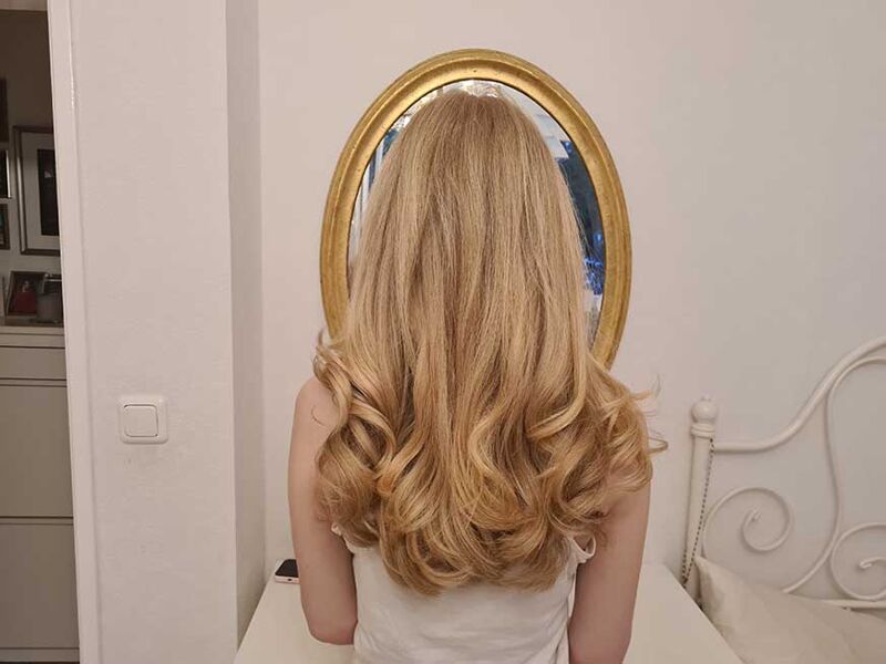 the DysonWoman showing her curls styled with Airwrap.